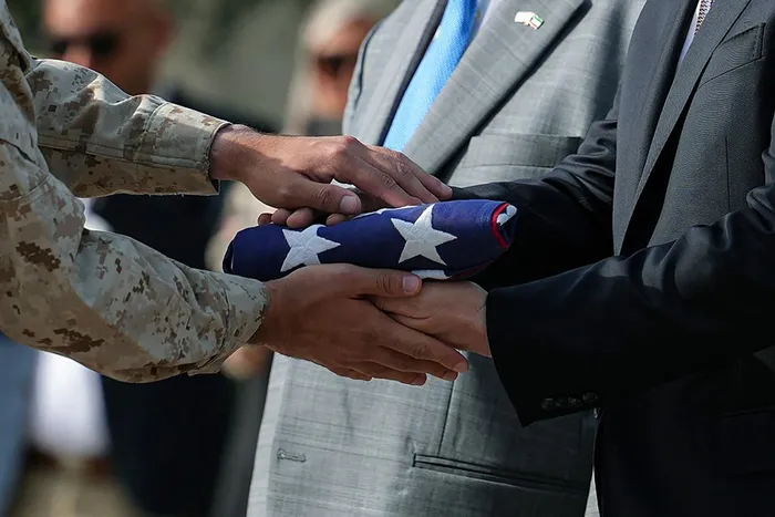 US Secretary of State Marco Rubio passes a US flag to a Marine during a flag raising ceremony at the US embassy amid his visit to the Middle East to discuss the interim deal between the US and Iran with Arab Gulf allies, in Kuwait City. Explore how the potential for peace in the Middle East is transforming global financial markets, despite ongoing inflation pressures and central bank policies.
