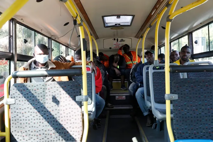 Buses arrive to transport Malawian immigrants to court, offering a glimmer of hope amid adversity.