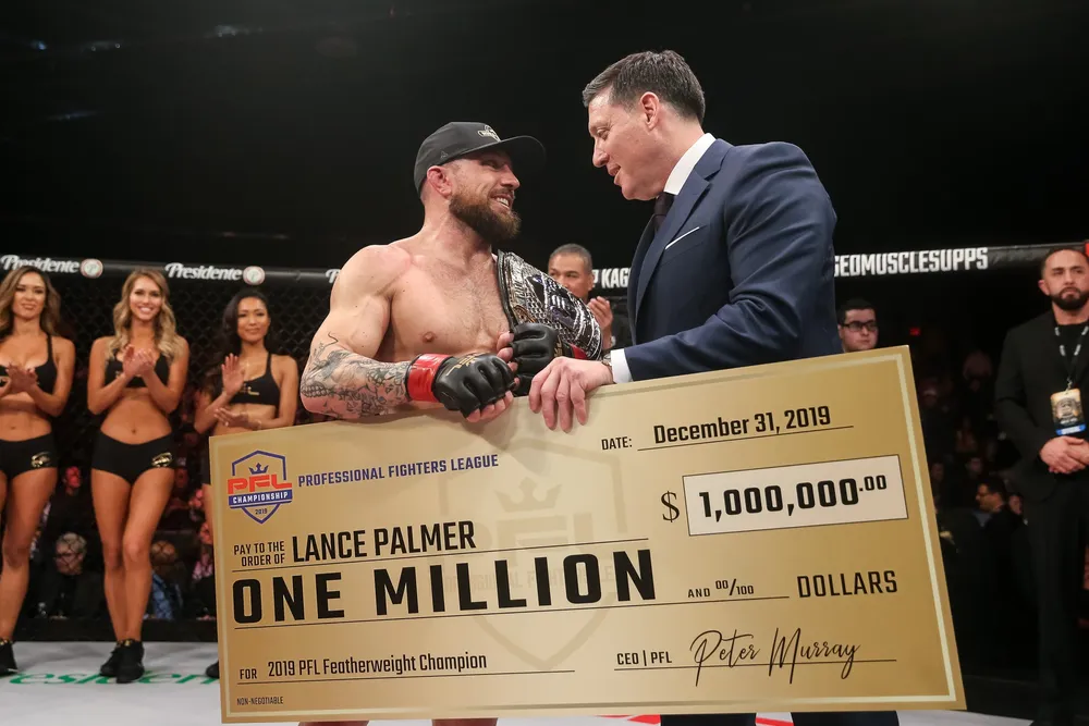PFL CEO Peter Murray awards the 2019 season winner, Ray Palmer with his handsome cash prize