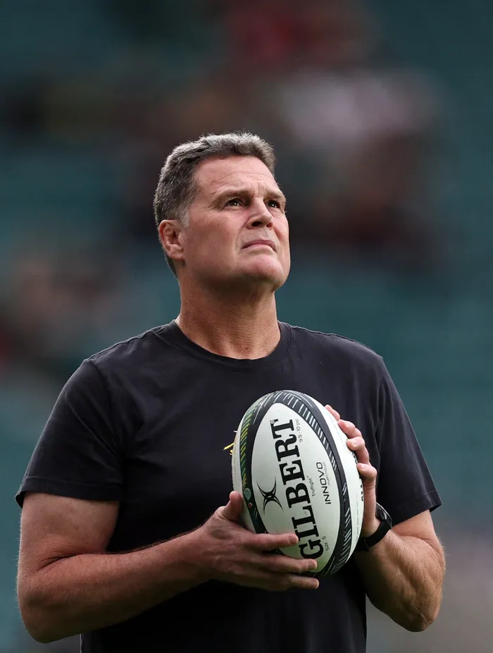 Rassie Erasmus holds a rugby ball