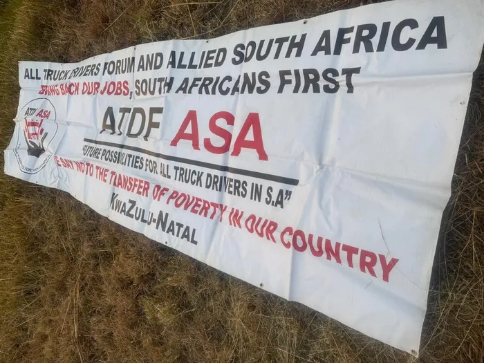 An ATDF-ASA banner discovered in the abandoned bakkie, linked to the incident that escalated into chaos and led to the arrests of the secretary general and two others during a peaceful protest.