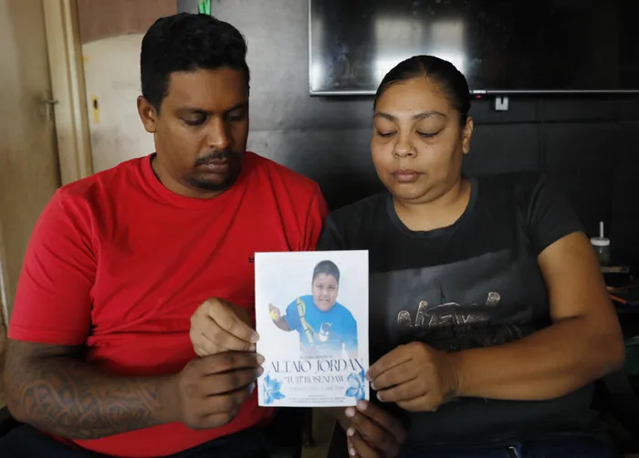 Grieving parents Nerissa Rosendaw and Kumiel Rosendaw hold a photograph of their youngest son Altaio.