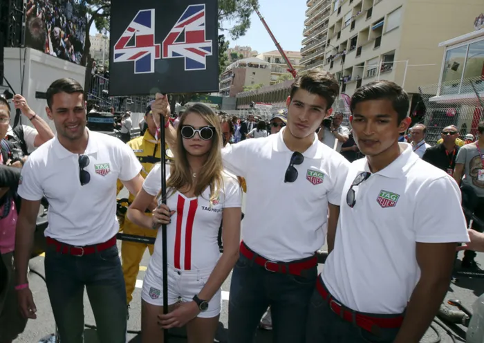 Cara Delevingne poses with a group of male models on the Monaco F1 starting grid. Photo: Reuters.