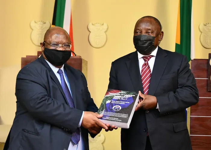 Chairperson of the Commission of Inquiry into State Capture, Deputy Chief Justice Raymond Zondo, hands over the first part of the state capture report to Presidency Cyril Ramaphosa at the Union Buildings. Picture: GCIS