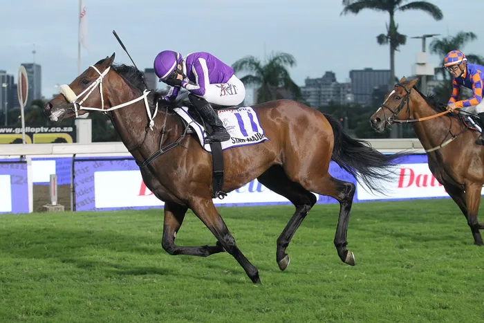Star Major, trained by James Crawford and ridden by Mickaelle Michel, powers its way to victory in the Grade 1 Daily News 2000 horserace run at the Hollywoodbets Greyville Racecourse.