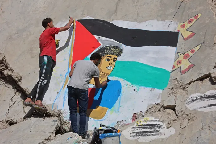 Graffiti artists paint a portrait of Lamine Yamal along with the Palestine flag. 