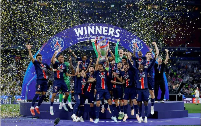 Paris St Germain's Marquinhos lifts the trophy as he celebrates with teammates after winning the Champions League on May 31.Fans got overly excited.