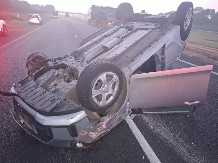 The damaged hatchback lies on the N17 after the vehicle collided with a truck and overturned several times.