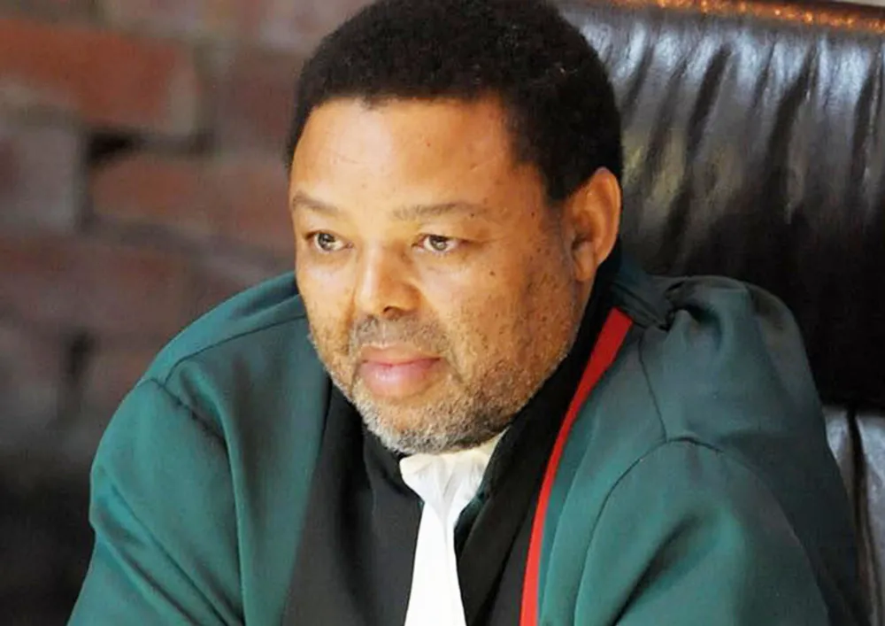 A judge in green robes 