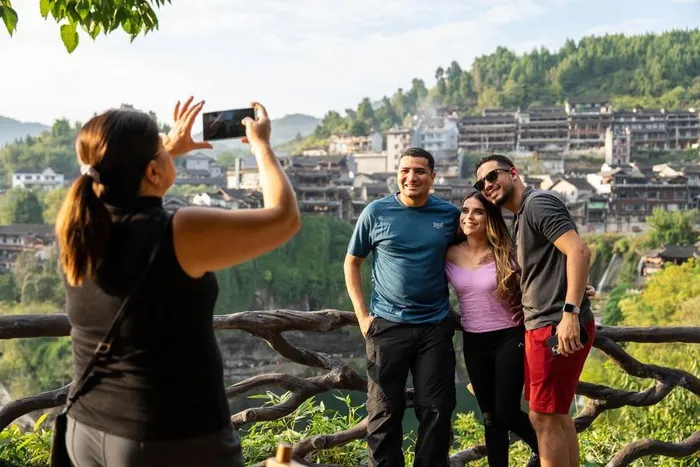 Foreign visitors take photos at the Furong Town scenic spot in Yongshun County, Xiangxi Tujia and Miao Autonomous Prefecture, central China's Hunan Province, November 7, 2024. 