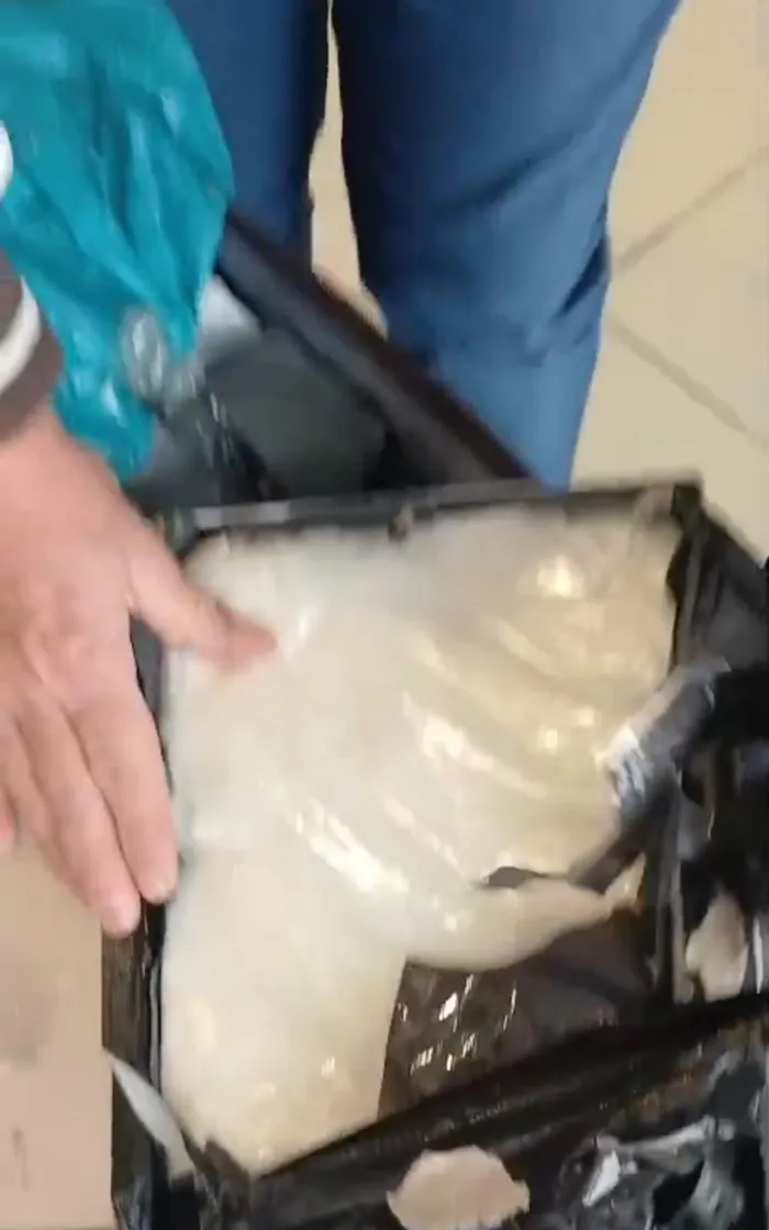 Police show off the nearly 2kg of cocaine seized when they arrested a 45-year-old man at OR Tambo International Airport.