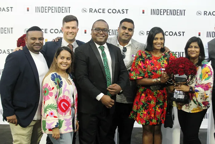 Editor of the Daily News, Ayanda Mdluli (centre) with the connections of the winning horse (Star Major) in the Daily News 2000 run at the Hollywoodbets Greyville Racecourse.