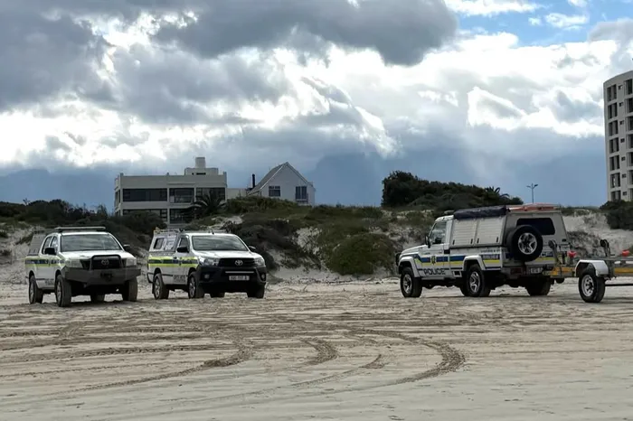 Police divers on Strand Beach last week. 