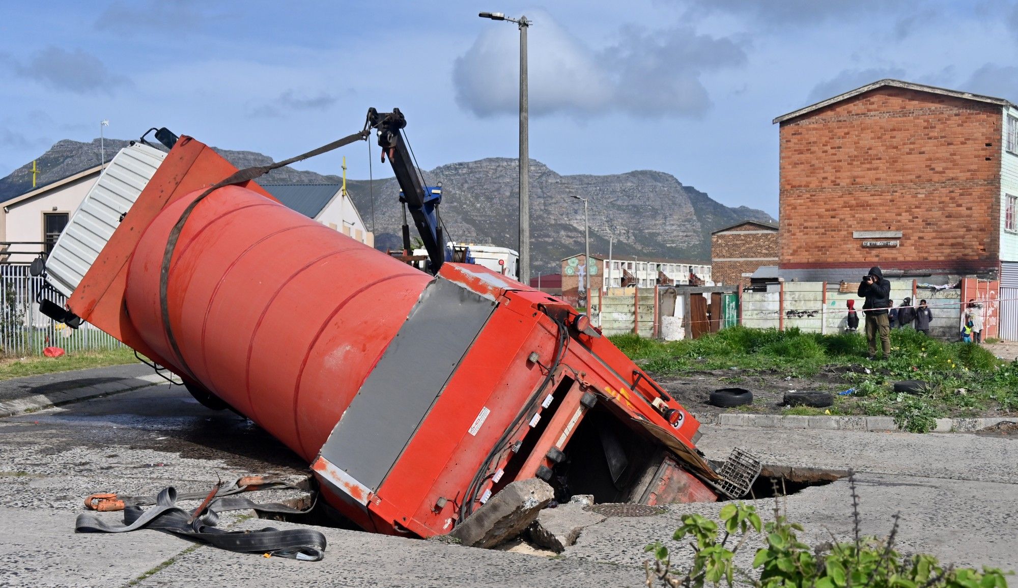 City’s refuse compactor truck stuck in a hole at Lavender Hill