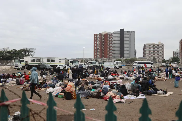Foreign nationals are waiting for buses at the Durban Drive-in repatriation site following its closure.