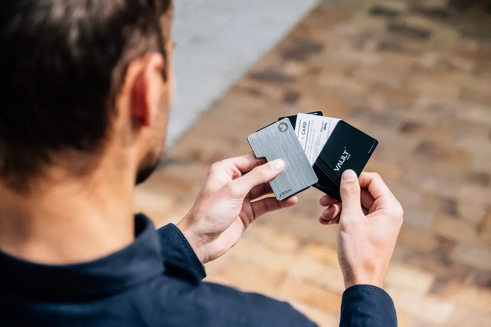 A man fans out business cards.
