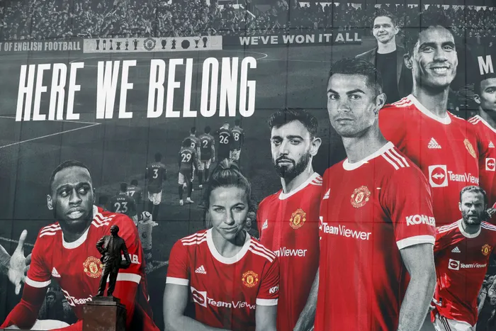 A picture of Cristiano Ronaldo with teammates is seen on the outside of Old Trafford. Photo: Phil Noble/AFP