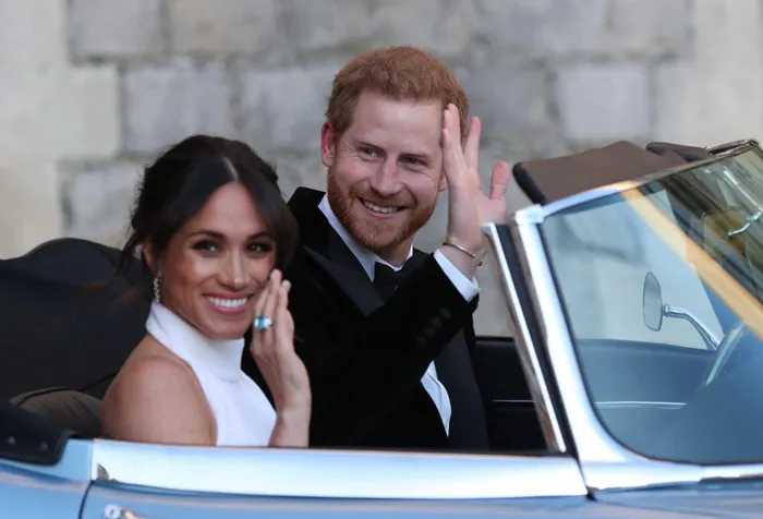 Prince Harry and Meghan Markle leave Windsor Castle in Windsor on May 19, 2018 after their wedding to attend an evening reception at Frogmore House.