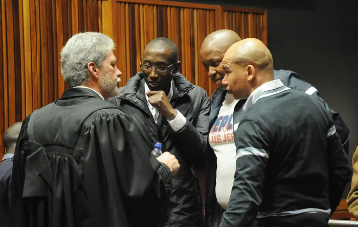 Marius Bouwer have a word with the three accused Kagiso Ledwaba, Thabo Mohapi and Garland Holworthy who appeared before the Palmridge Magistrate Court on August 6, 2013, facing charges of kidnapping, theft and murder of Uwe Gemballa.