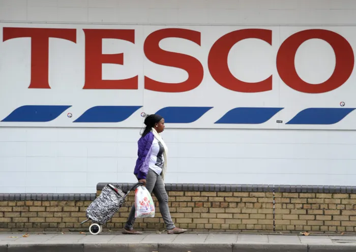 A shopper leaves a Tesco supermarket in London. File photo: Facundo Arrizabalaga