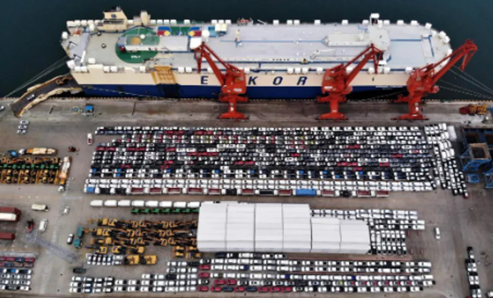 Aerial photo taken on Aug. 7, 2022 shows commercial vehicles before their shipment onto a ro-ro cargo vessel to depart for Africa at Qingdao Port in Qingdao, east China's Shandong Province. (Xinhua/Li Ziheng)