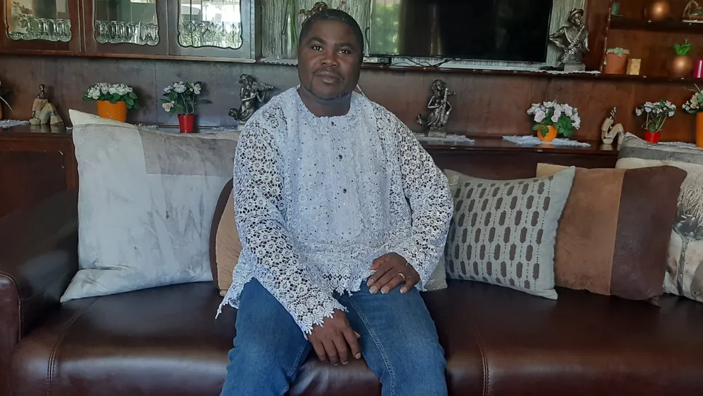 Professor Abdon Atangana sits on a couch.