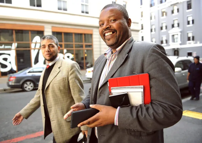 Cape Town 150903. Sam Buthelezi,(right) one of the alleged masterminds behind the misappropriation of R500 million of the trilinear empowerment trust's pension fund appeared at Cape high court this morning. He is with his laywer( left) Rooshdean Rudolph Picture Cindy waxa.Reporter Zodidi/Argus
