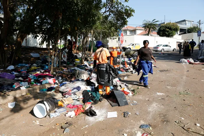 Residents and vagrants sift through the remnants left behind, searching for items that can be reused or sold, while municipal workers continue the cleanup. 