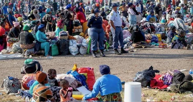 Crowds of foreign nationals form structured queues at the Durban Drive-In site while authorities manage processing and transport logistics as repatriation efforts continue ahead of planned protests.