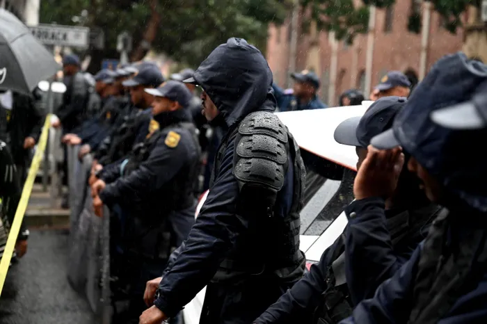 SAPS officers monitor the March and March, Operation Dudula and LACO protest at Home Affairs on Thursday.