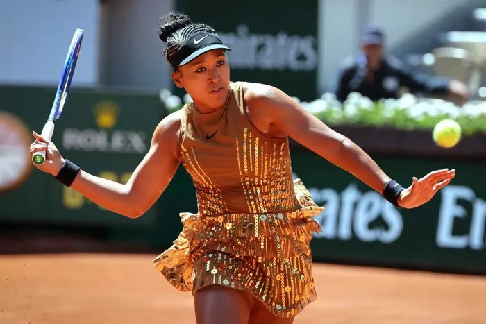 Japan's Naomi Osaka stuns in a gold glittering outfit during the women's singles match on day 3 of the French Open tennis tournament