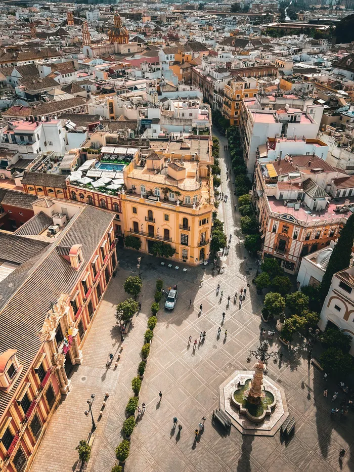 A stunning aerial shot of Seville's cityscape showcasing Spanish Baroque architecture and urban life.

