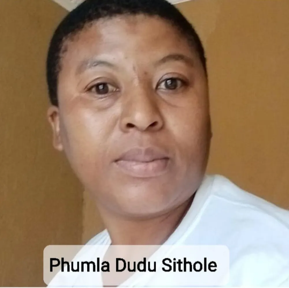 A face of a woman with short hair wearing a white T-shirt 