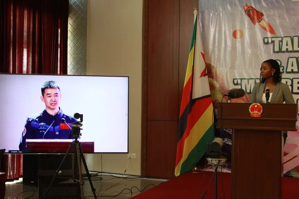 Nicole Njanjari, a participant of the ‘My Dream’ painting competition for African youth, listens while a Chinese astronaut responds to her question during an awarding ceremony of the competition in Harare, Zimbabwe, Sept. 13, 2023. Photo by Tafara Mugwara/Xinhua
