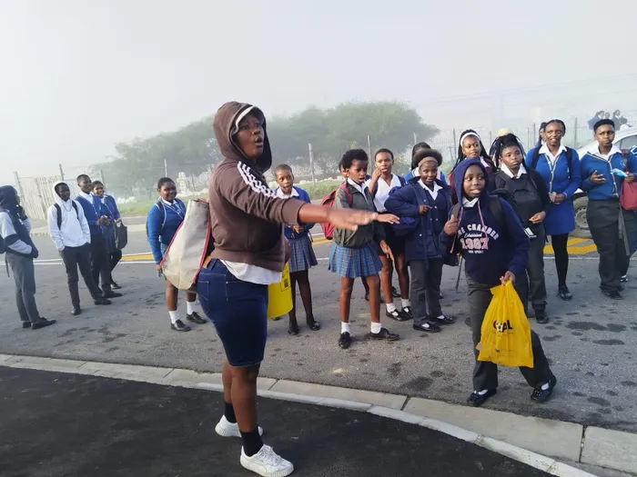 This unidentified woman was not happy with the closing of the school gate because she wanted to sell her stuff.