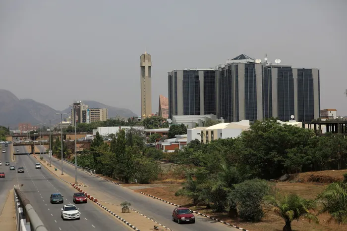 FILE PHOTO: Cars drive past the Central Bank of Nigeria headquaters in Abuja