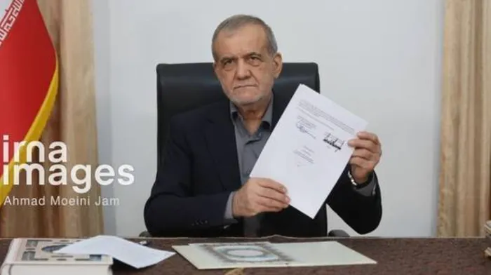 Iranian President Masoud Pezeshkian holds the signed memorandum of understanding with the United States, June 18, 2026 