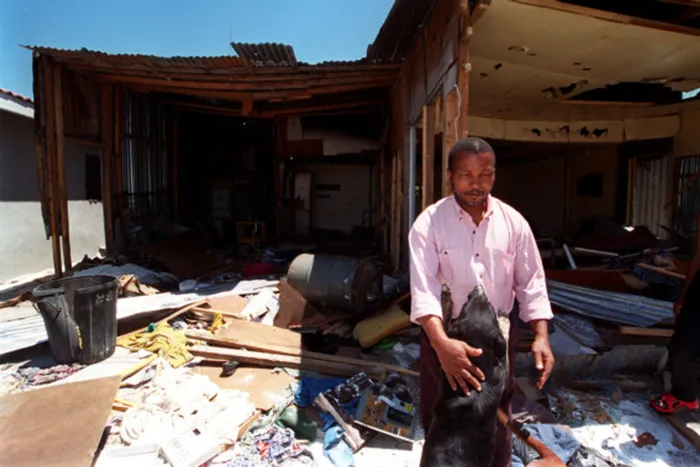 PAIN OF LOSS: This man's house was destroyed after his son was burnt to death in an act of vigilantism. Daily in our townships, residents " predominantly young men " are being injured or killed by mobs meting out "people's justice", says the writer. Picture: Enver Essop