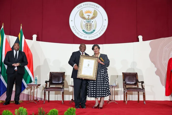 Prof. Priscilla Baker, a leading scientist at the University of the Western Cape (UWC), receiving her Order of Mapungubwe Bronze certificate from pres. Cyril Ramaphosa. 