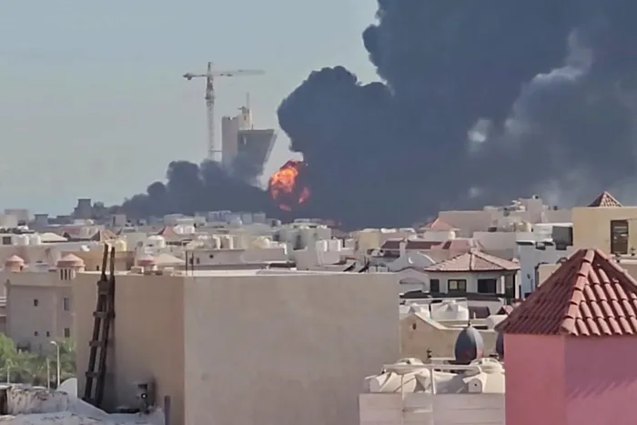 This screen grab taken from UGC video footage posted on social media on July 18, 2026, shows a plume of black smoke and flames billowing over the town of Mangaf, south of Kuwait City.