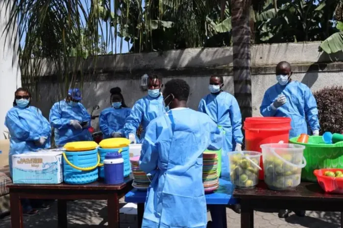 Staff members prepare meals for people under quarantine in Goma, the Democratic Republic of the Congo