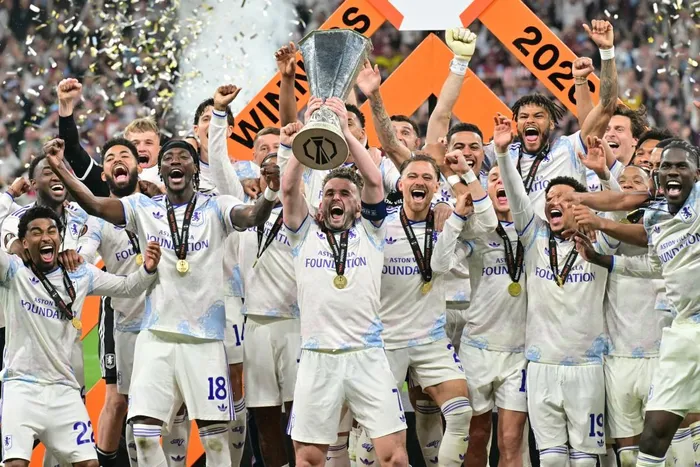 Aston Villa's Scottish midfielder John McGinn and his teammates celebrate with the trophy after winning the UEFA Europa League final football match against SC Freiburg at Besiktas Park in Istanbul on May 20, 2026. Picture: Stefano RELLANDINI / AFP