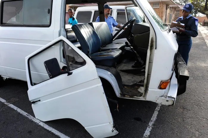 Traffic officers inspect an overloaded taxi door during a scholar transport operation. Picture: ANA Archives