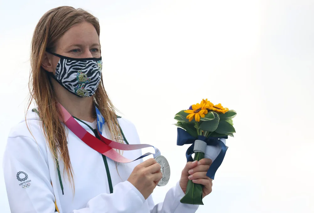 Surfing silver medallist, Bianca Buitendag of South Africa wearing a protective face mask poses on the podium