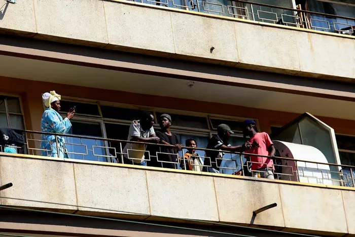 Some foreign nationals observed from their balconies as anti-illegal immigration protesters made their way through Sunnyside, Pretoria, on Tuesday