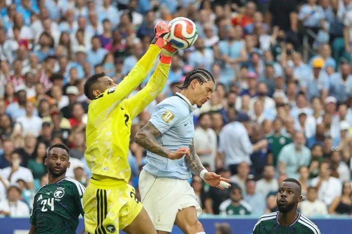 Saudi Arabia's goalkeeper Mohammed Al-Owais clears the ball next to Uruguay's forward Darwin Nunez during the 2026 World Cup Group H football  the Miami Stadium in Miami Gardens on June 15, 2026. 