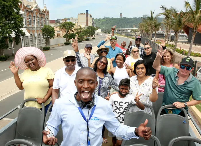 Durban Tourism guide Philani Sangweni, centre front, with the “Independent on Saturday” readers who won tickets for a rickshaw ride through historic Durban, visiting some of the places that have featured in our popular Then & Now series and coffee table books. Picture: Shelley Kjonstad African News Agency (ANA)