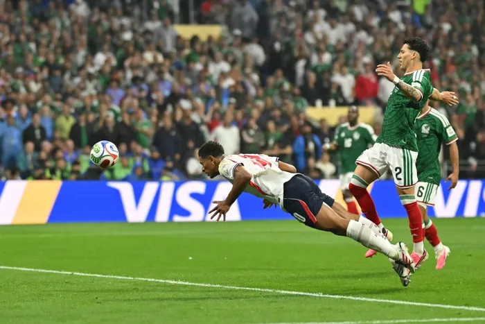 Jude Bellingham dives to head home the first of his two goals in England's 3-2 victory over co-hosts Mexico at the Azteca Stadium in Mexico City.